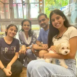 A Curious Tails customer with their new puppy in Singapore