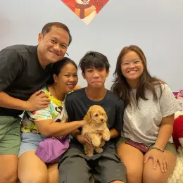 A Curious Tails customer with their new puppy in Singapore