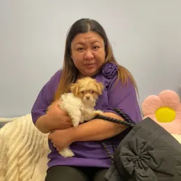 A Curious Tails customer with their new puppy in Singapore