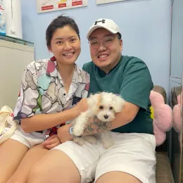 A Curious Tails customer with their new puppy in Singapore
