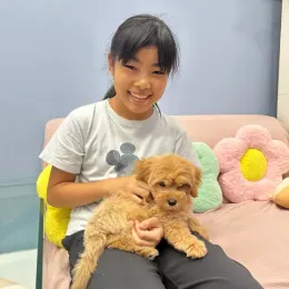 A Curious Tails customer with their new puppy in Singapore