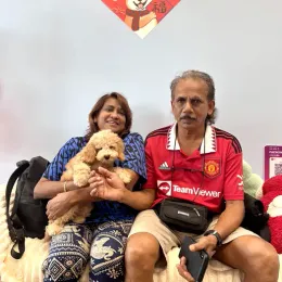 A Curious Tails customer with their new puppy in Singapore
